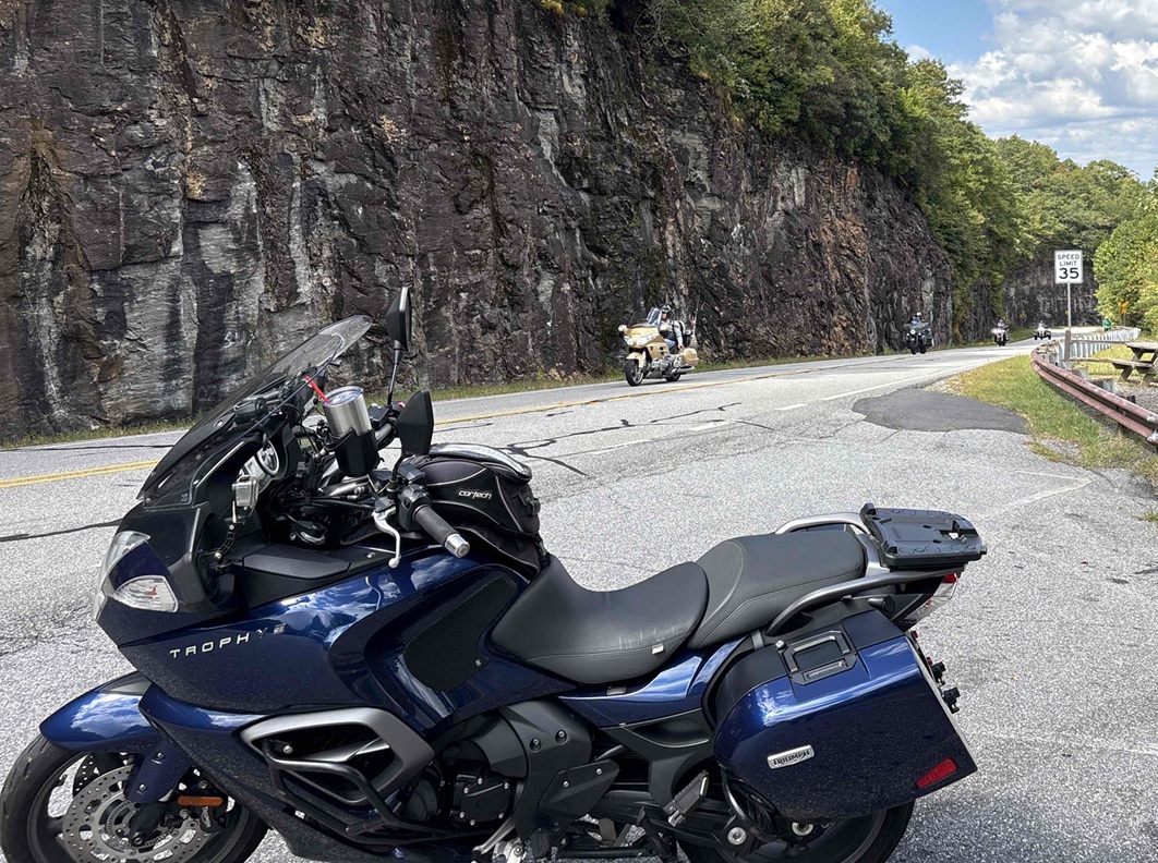 Blue Triumph Trophy motorcycle at a scenic stop
